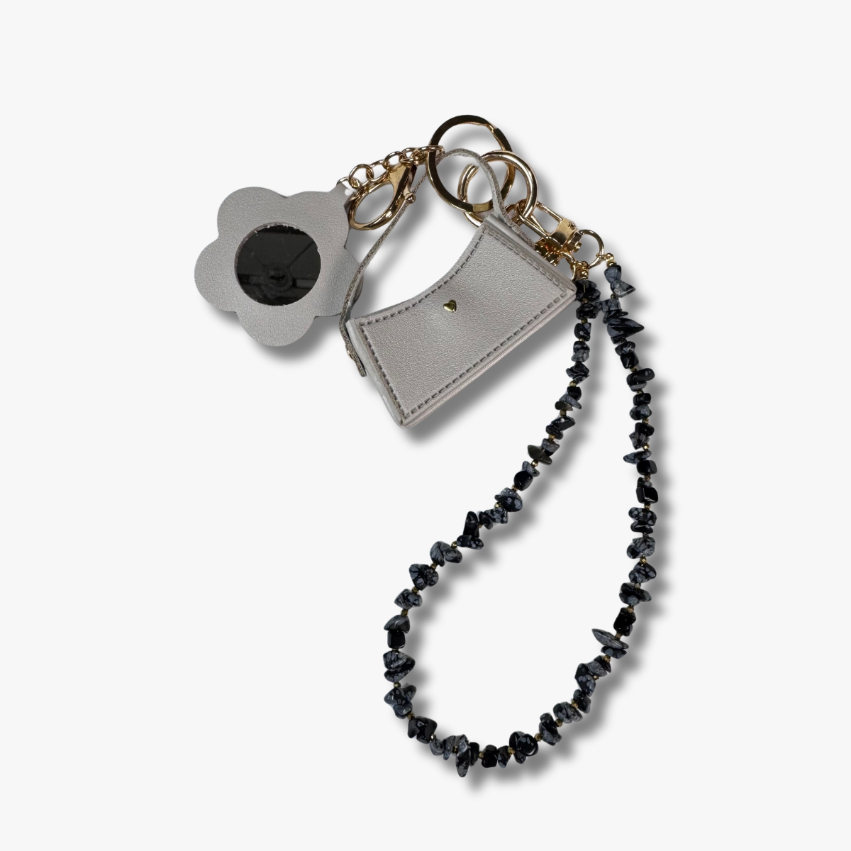 Keychain with black beaded chain, gray pouch, and flower-shaped charm on a white background