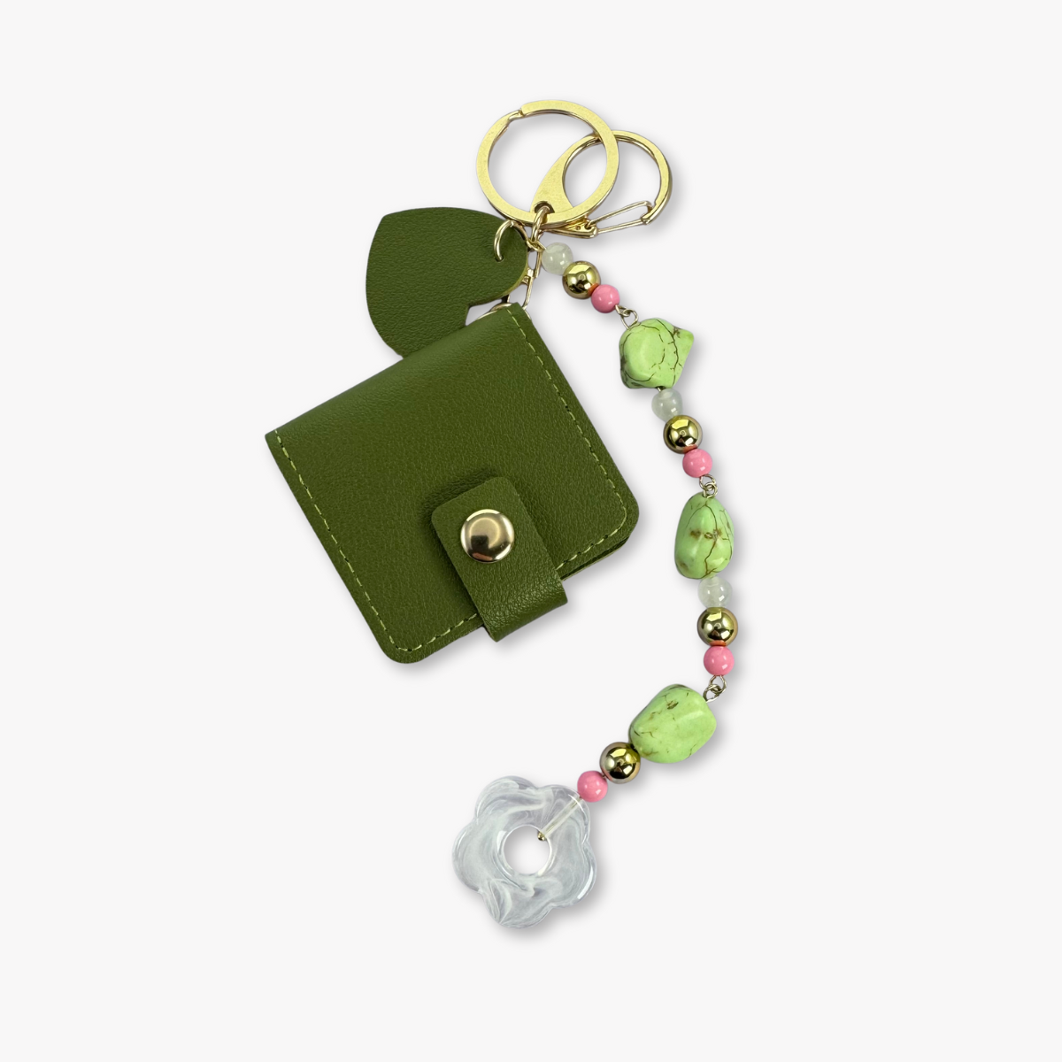 Green keychain wallet with decorative beads on a white background